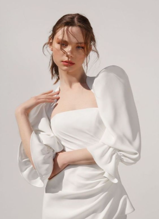 Modelo usando um vestido branco com manga princesa